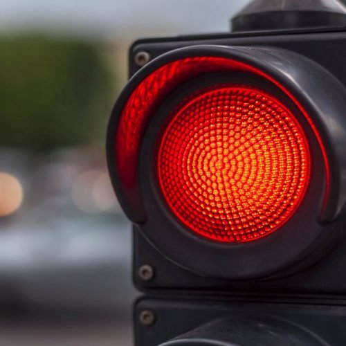 Red traffic light in the city street